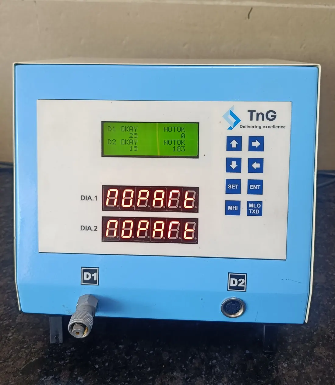 TnG gauge with two red 7-segment readouts labelled DIA 1 and DIA 2 and a green LCD.
